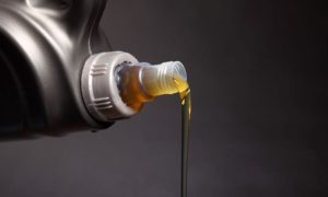 fresh oil being poured out of a jug