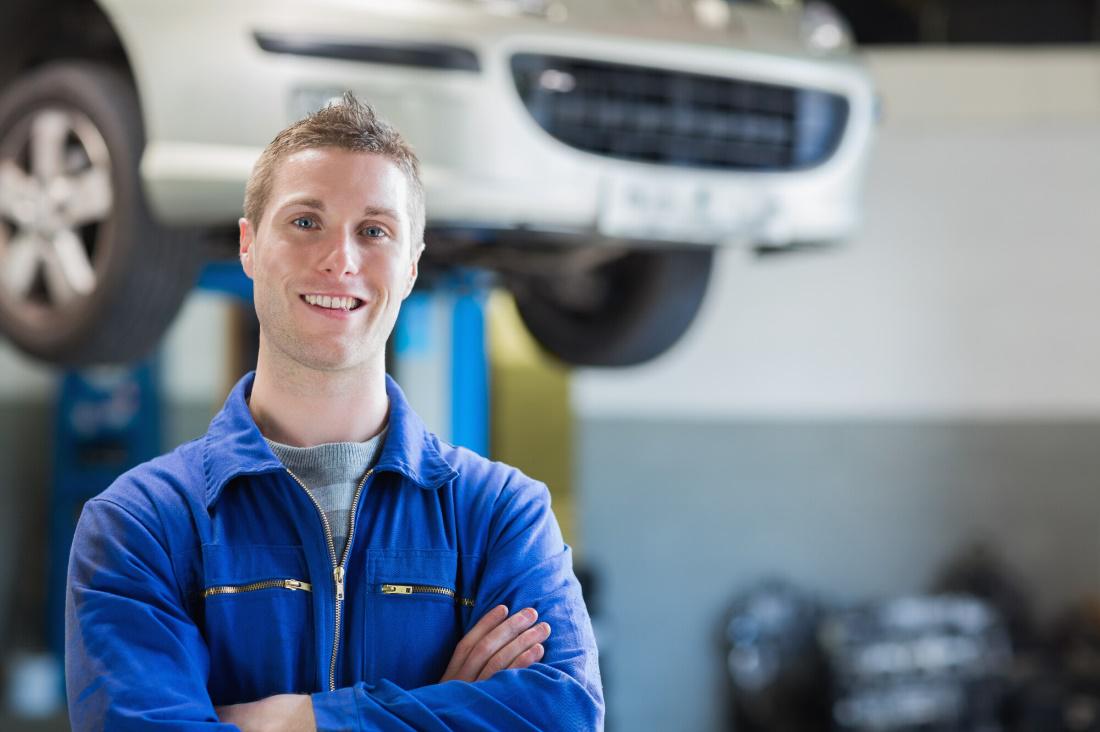 Mechanic in front of the car