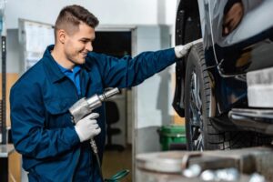 A mechanic working on the tire of an electric car